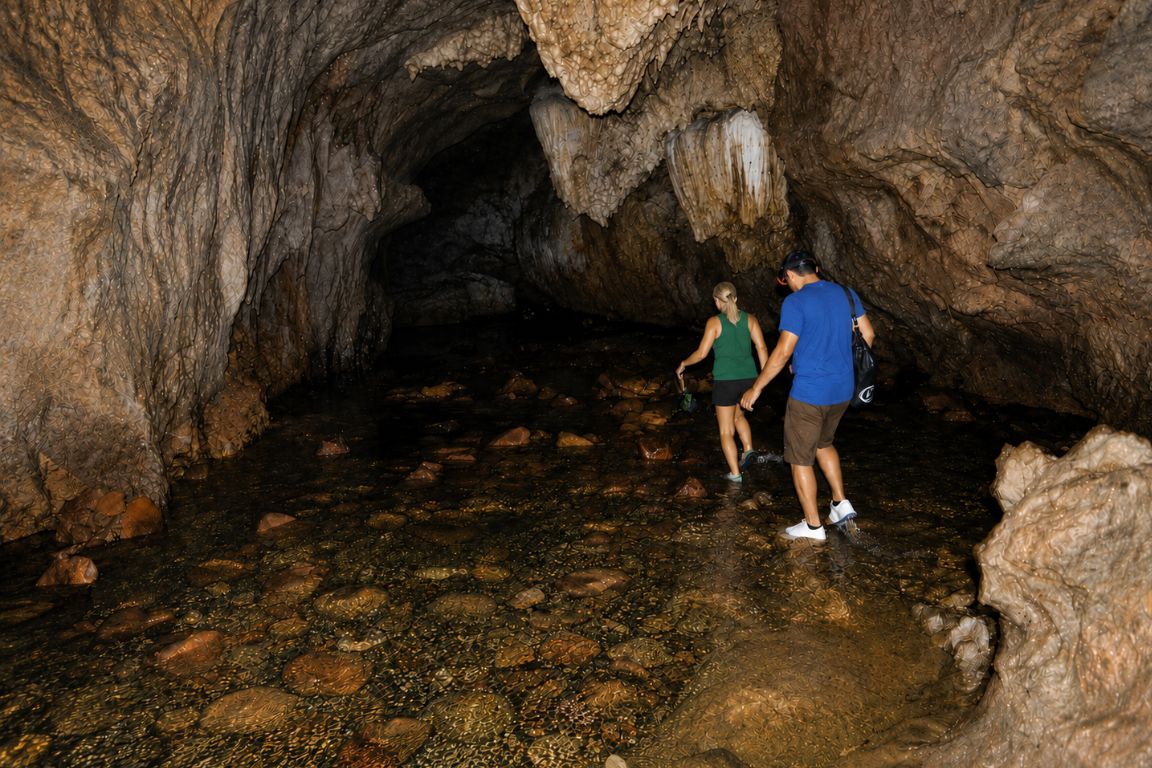 Travelers exploring Nam Talu Water Cave during a guided Khao Sok National Park Tours adventure in Thailand